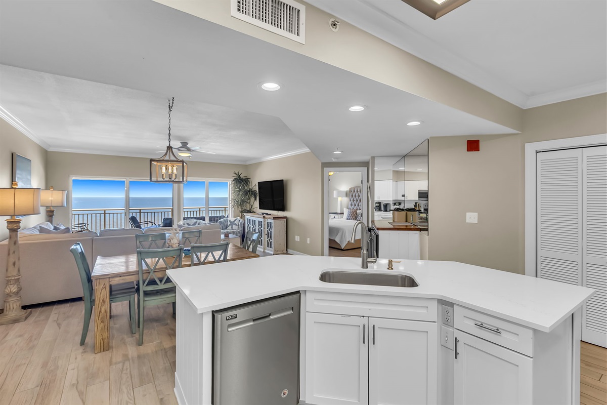 Imagine preparing delicious meals with ease in this well-appointed kitchen, all while staying connected with family and friends in the adjacent living and dining areas. This open-concept design is ideal for a relaxed coastal lifestyle.