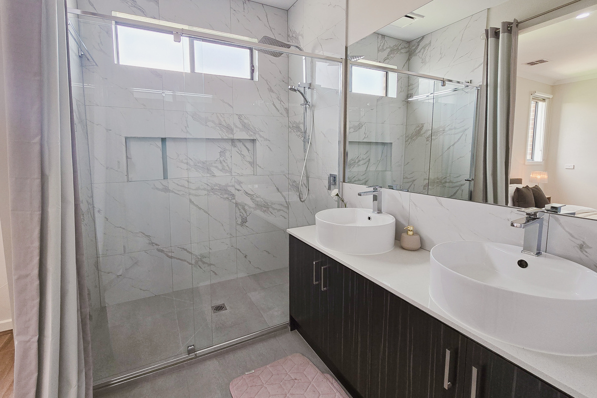 This bathroom at Willows Stays Holiday adds a fresh, practical space to the stay, with a walk-in shower, double vanity and natural light.