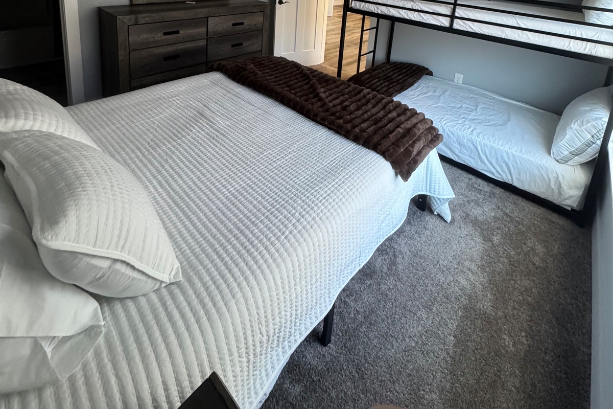Queen bedroom with twin/twin bunks. Ceiling fan and private bath