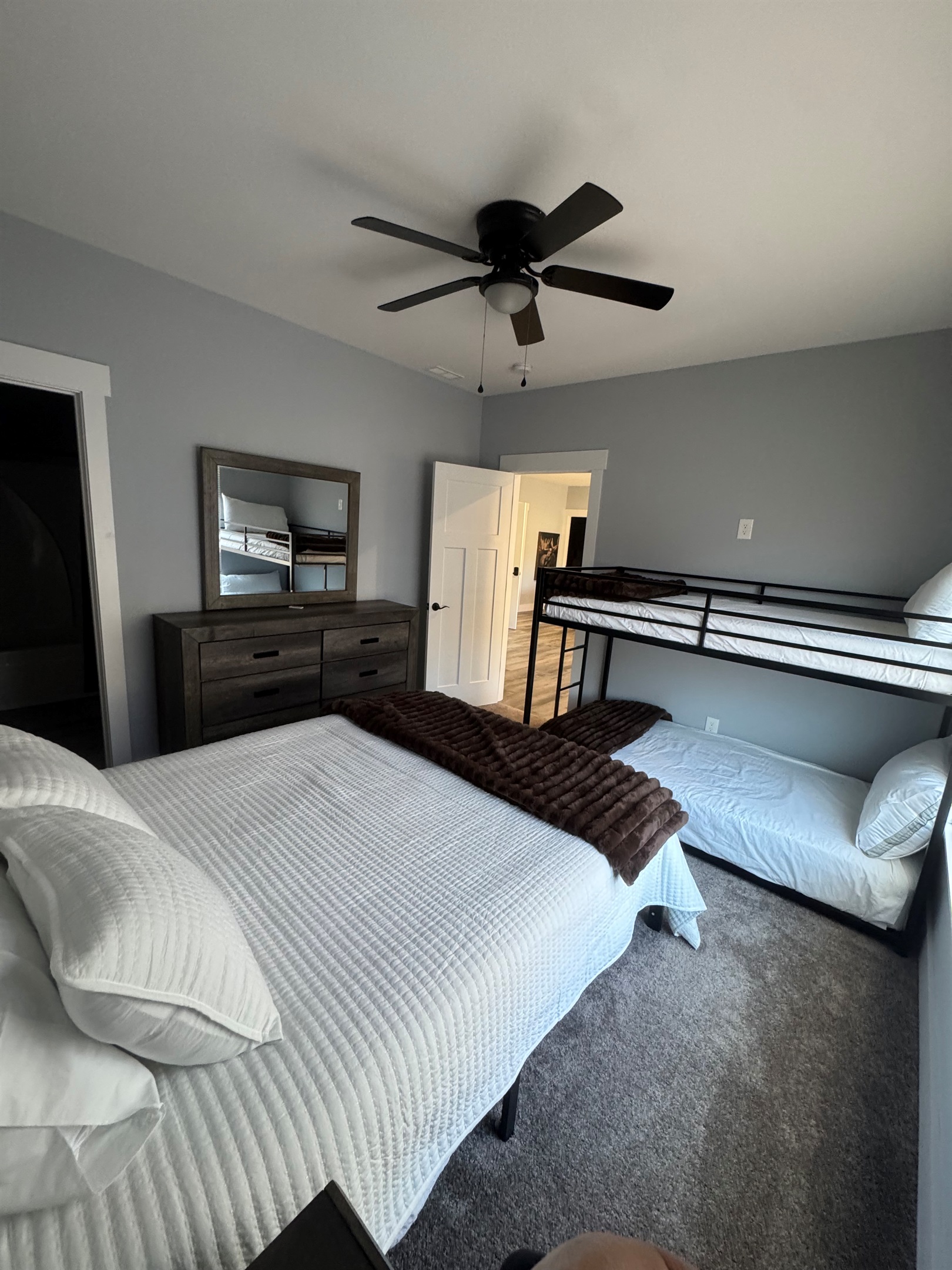 Queen bedroom with twin/twin bunks. Ceiling fan and private bath