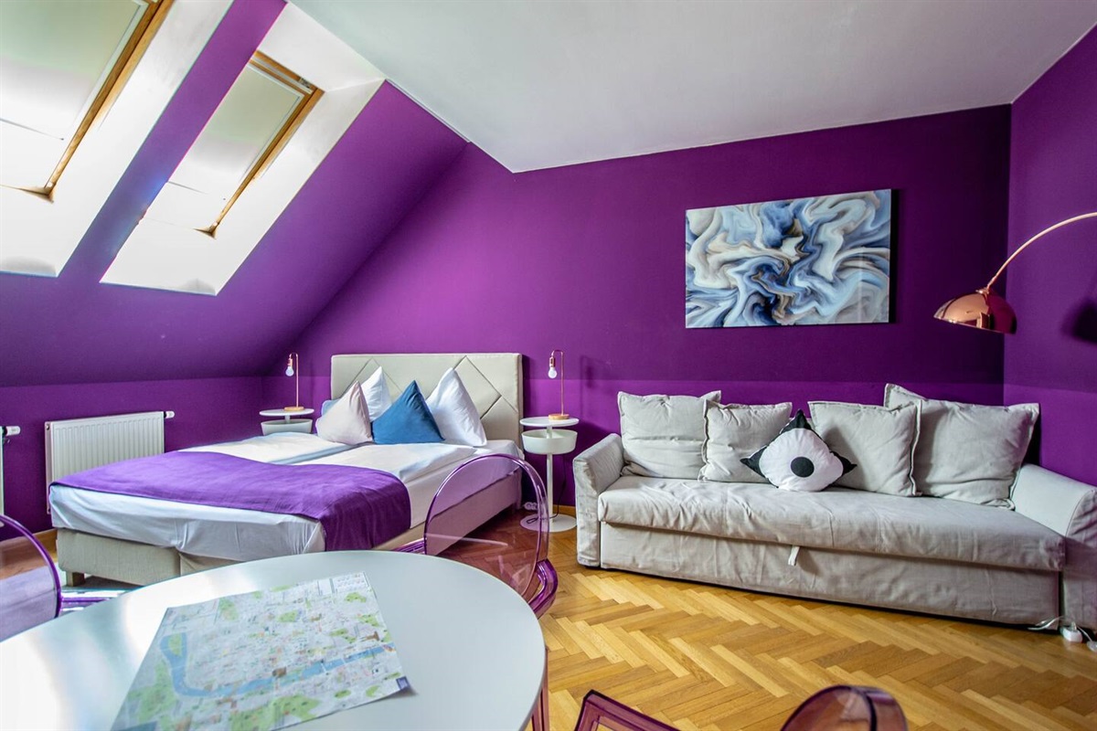 Big comfortable bed with convertible sofa in the main bedroom