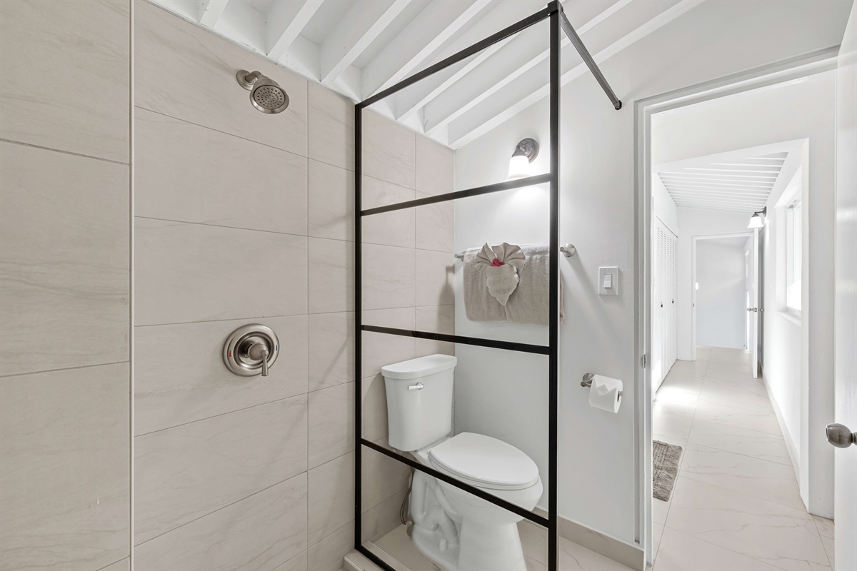 Guest ensuite bathroom with large vanity and closet space