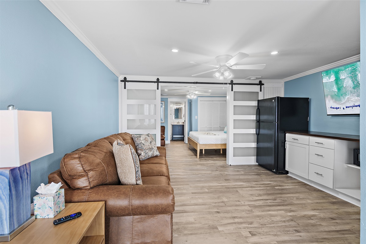 Costa Del Sol A-9: The 1st Floor features another Living Room w/ 65" Smart TV, Leather Sleeper Sofa, Multi-Game Arcade Console, a Kitchenette, and Beachfront Patio Access - Great for the Kids!