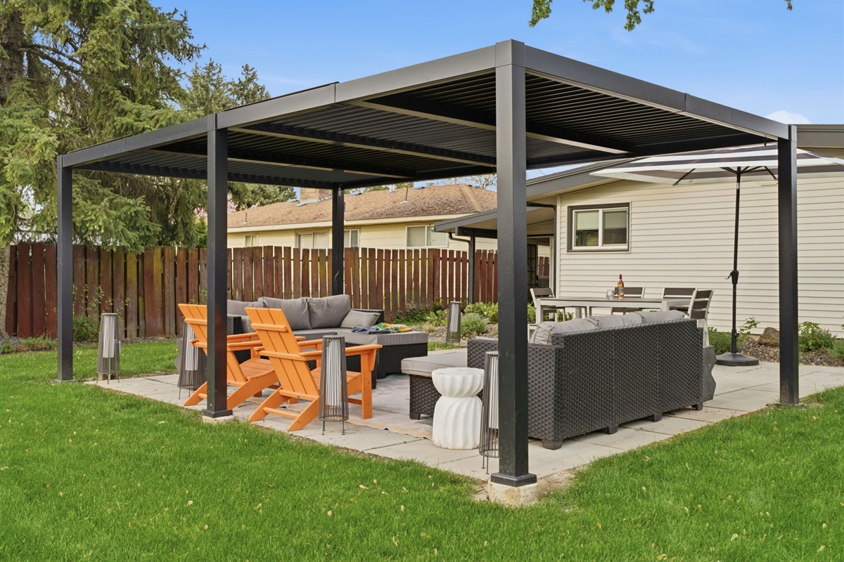 Patio area w/ dining table. covered lounge area.