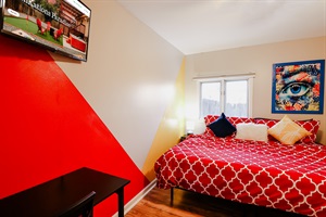 A room thoughtfully equipped with a TV for relaxation and a study table for work or study, blending entertainment and productivity seamlessly.