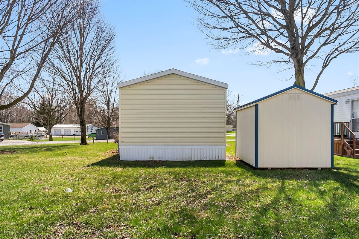 Rear view of the property with ample yard space, ideal for relaxing outdoors.