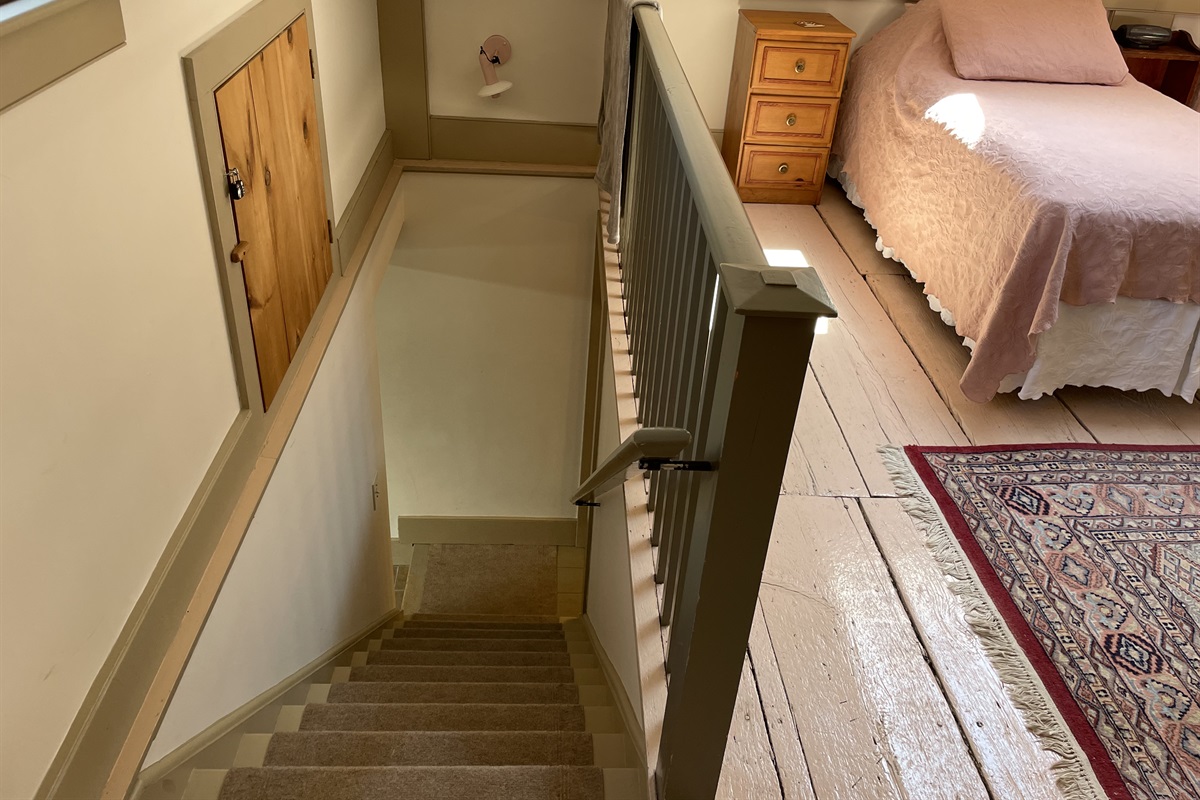 Stairs off the kitchen leading to twin loft.