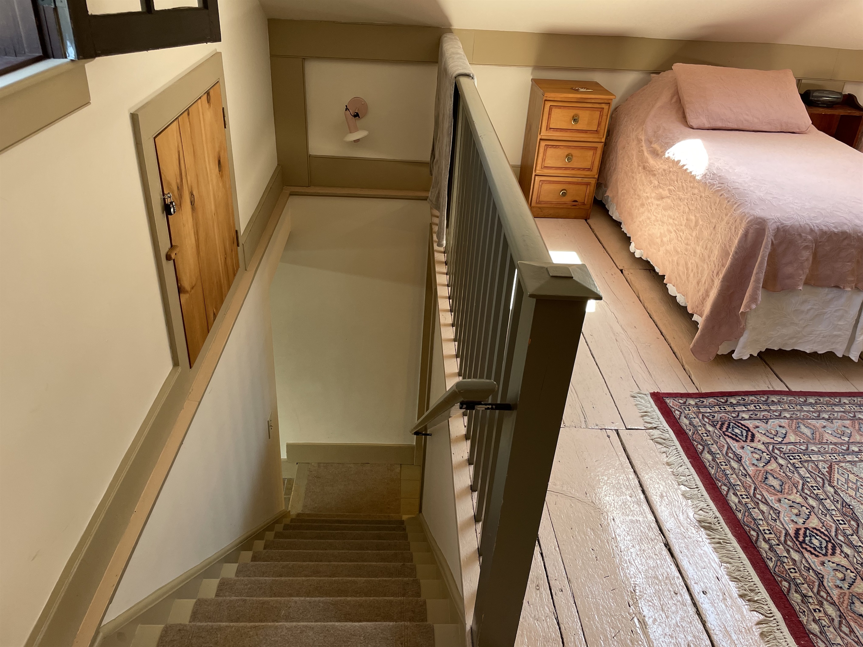 Stairs off the kitchen leading to twin loft.