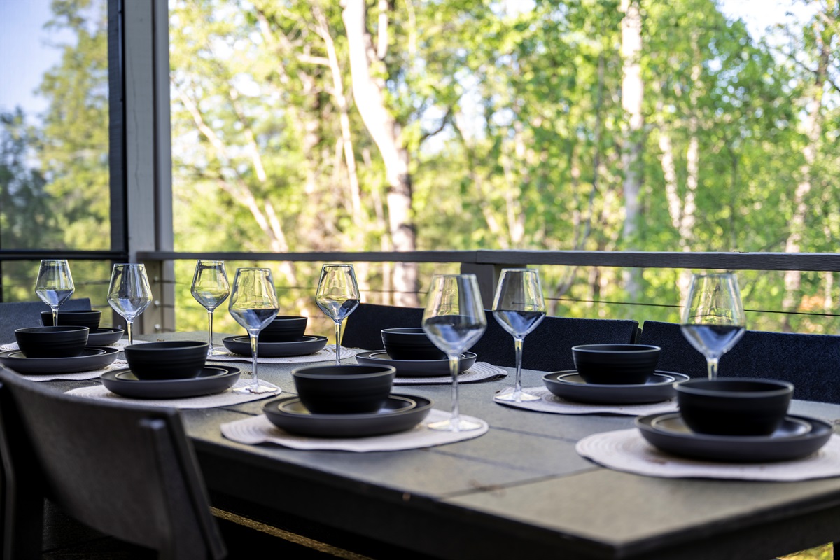 Dine al fresco surrounded by mountain & forest views. This spacious outdoor dining table is set for eight, perfect for everything from casual brunch to elegant evening meals under the trees.