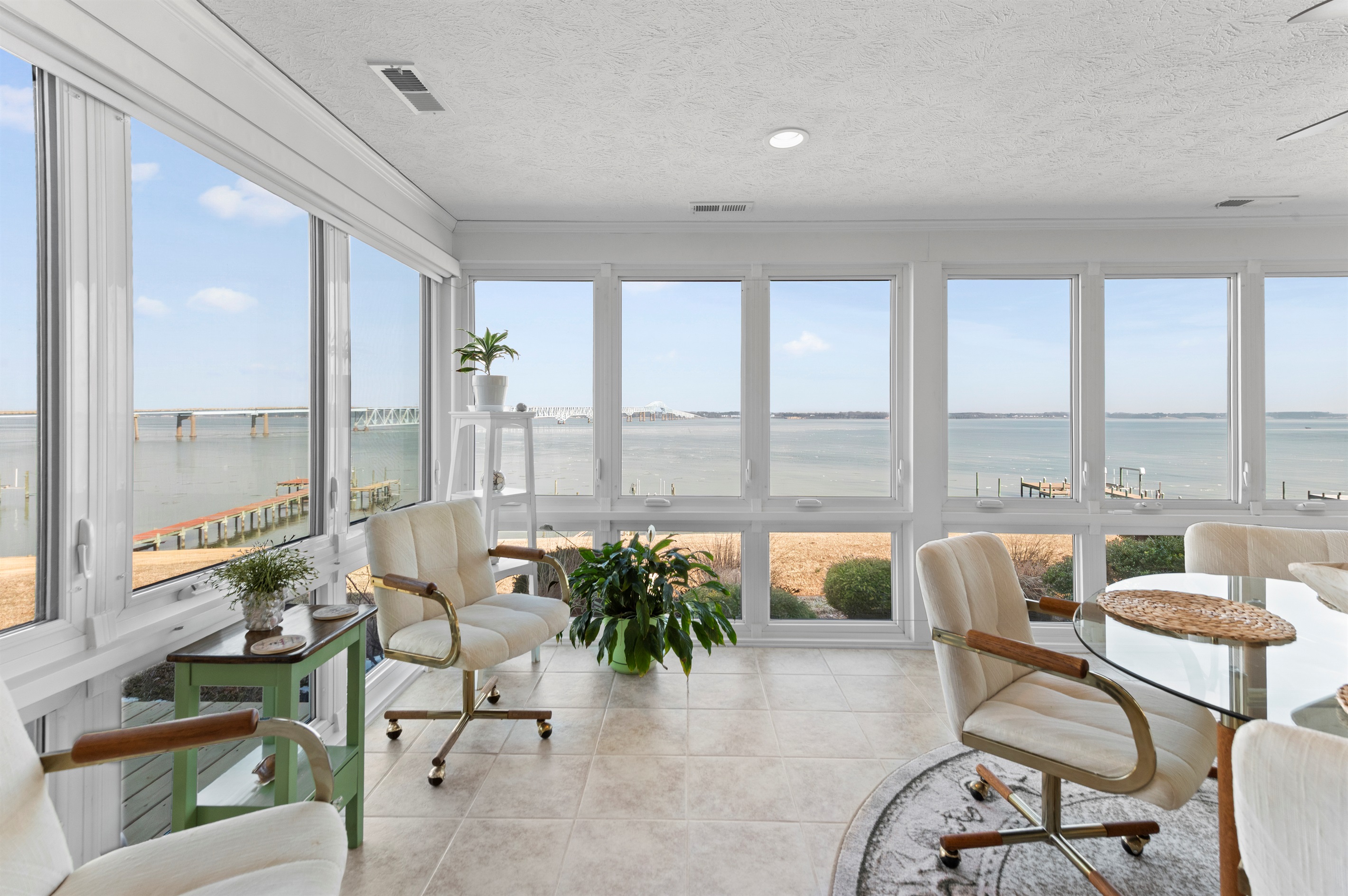 Sunroom Retreat: Bask in panoramic water views while sipping coffee or reading a good book!