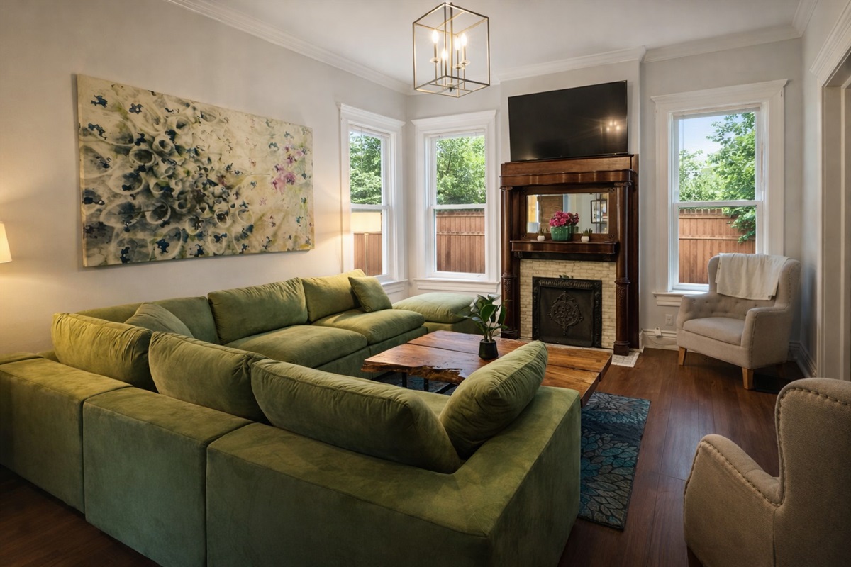 Living Room with Velvet Large Section Sofa and addition side chairs. 55" LED Smart TV.