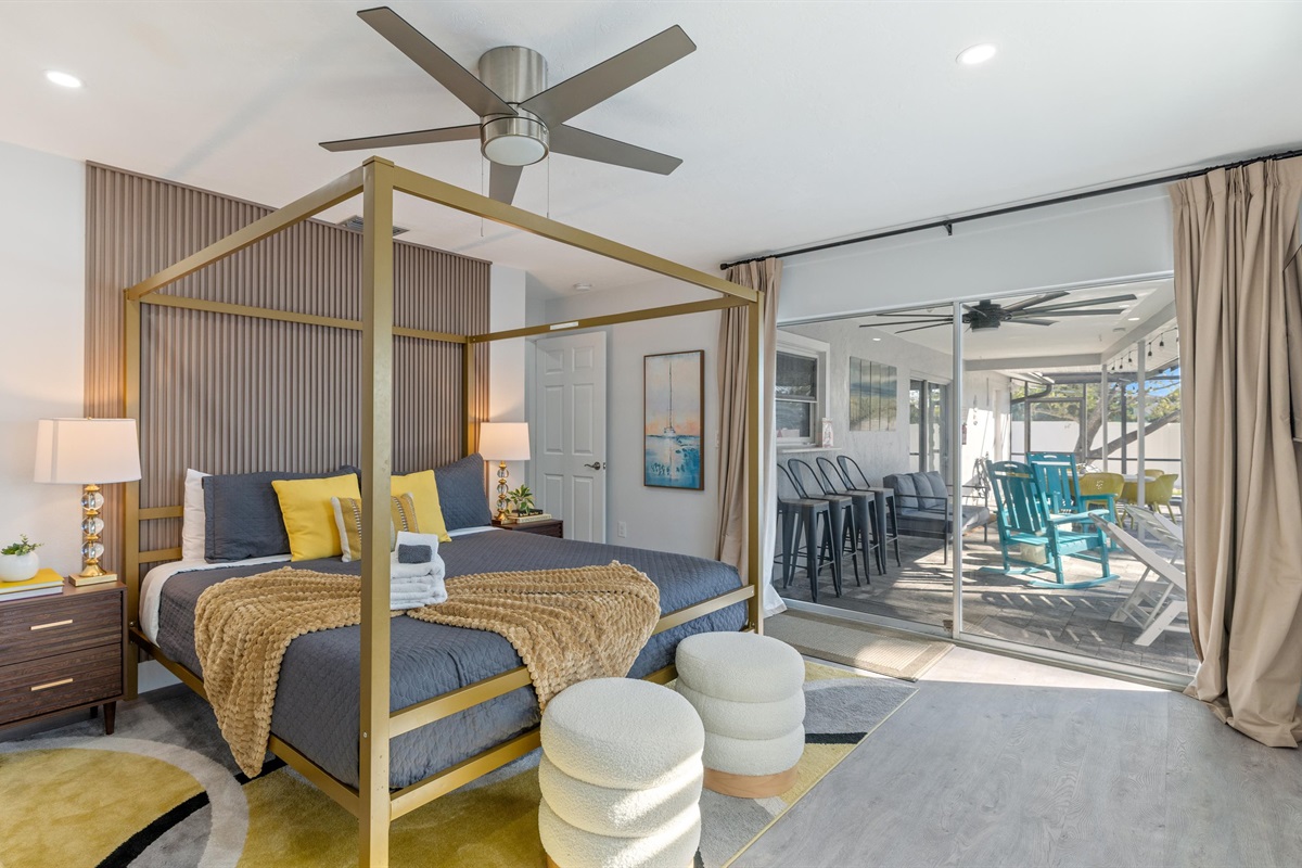 Second bedroom, with a King sized four-poster bed, and doors opening up directly to the pool area.