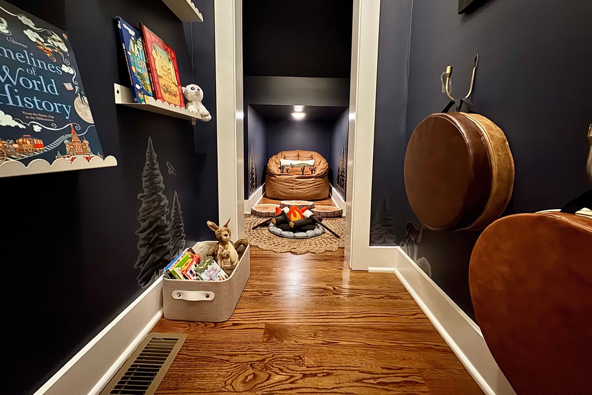 Welcome to the Scenic Sky forest library, located under the stairs in the bunk room! This deep closet is now a magical spot for kids (or adults) to get lost in a good book, or enjoy a pretend s'more under the starry sky.