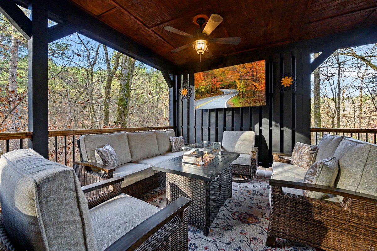 Outdoor living room with TV, fireplace, and comfy seating 🍷📺