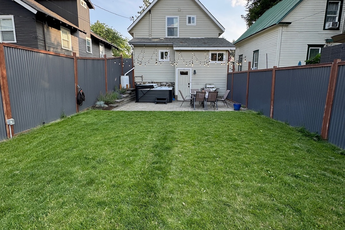 Fenced backyard with private hot tub