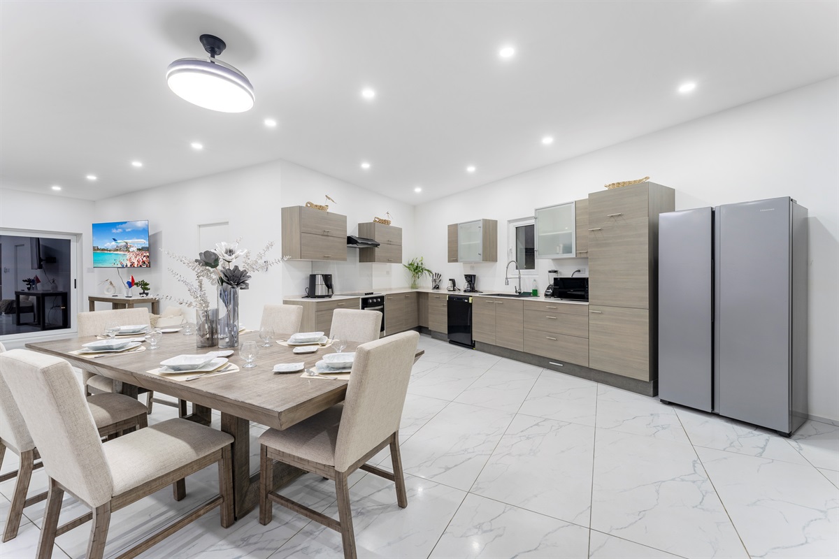 Full view of modern kitchen with dining table set for six