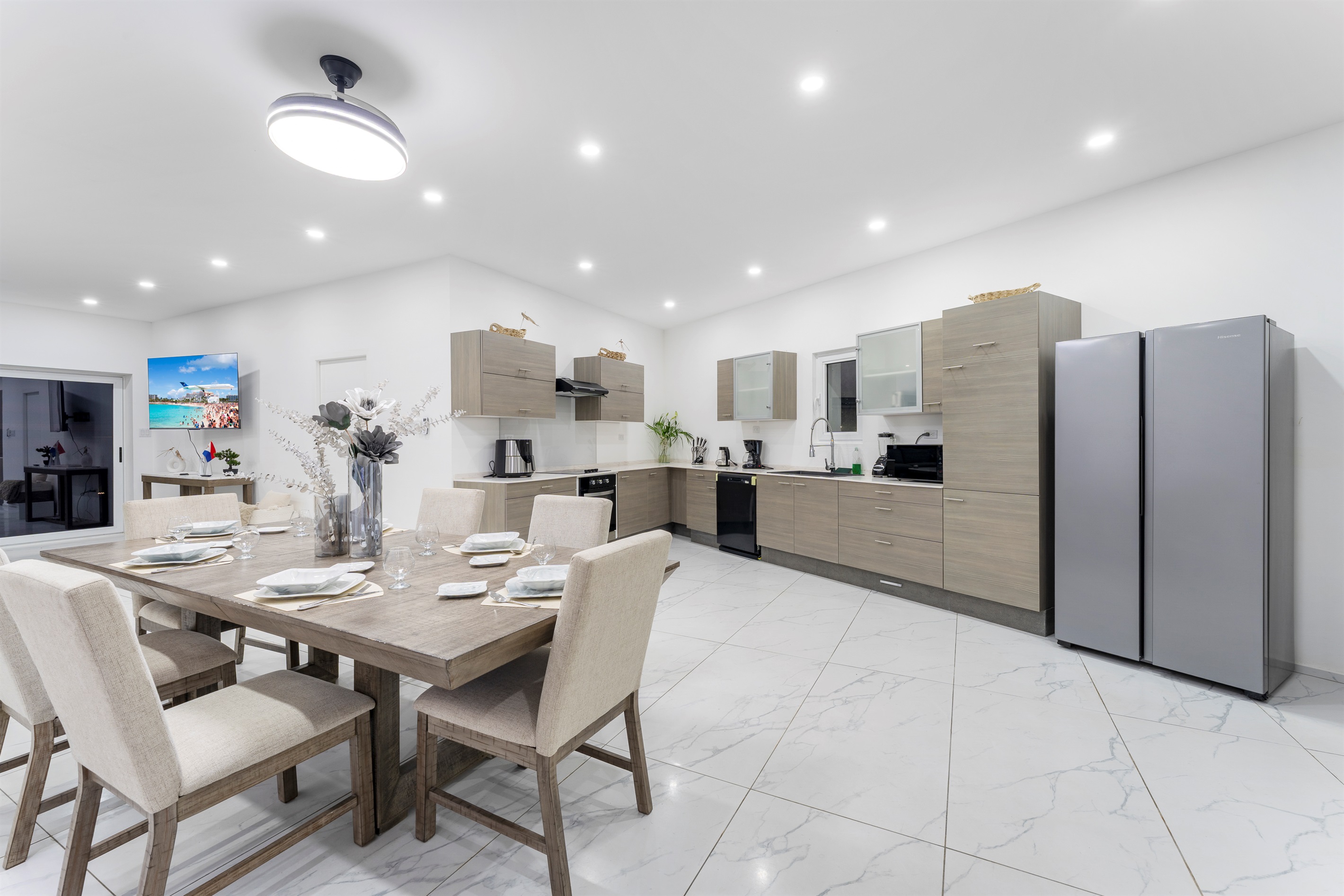 Full view of modern kitchen with dining table set for six