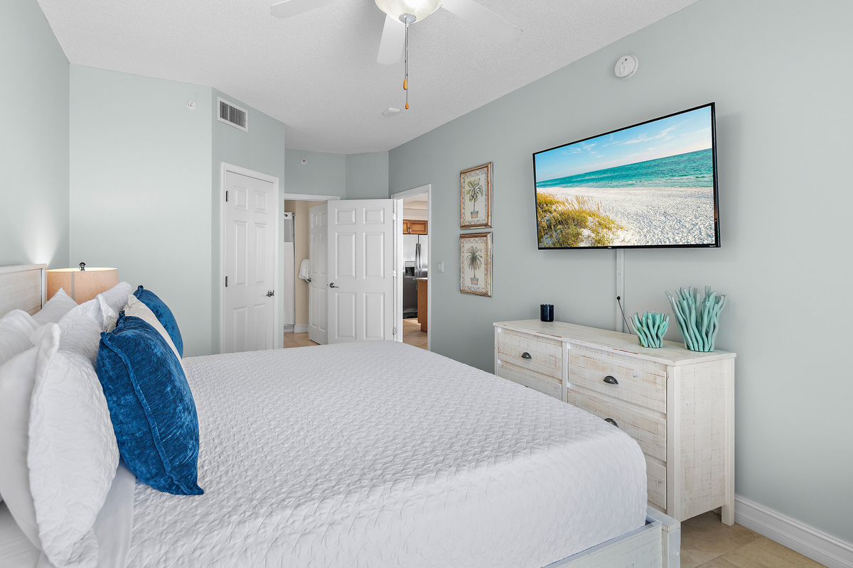 Spacious master bedroom features a King bed, Gulf views, balcony access, SMART TV w/ cable access, bathroom with dual vanity and shower/tub combo, and large closet.