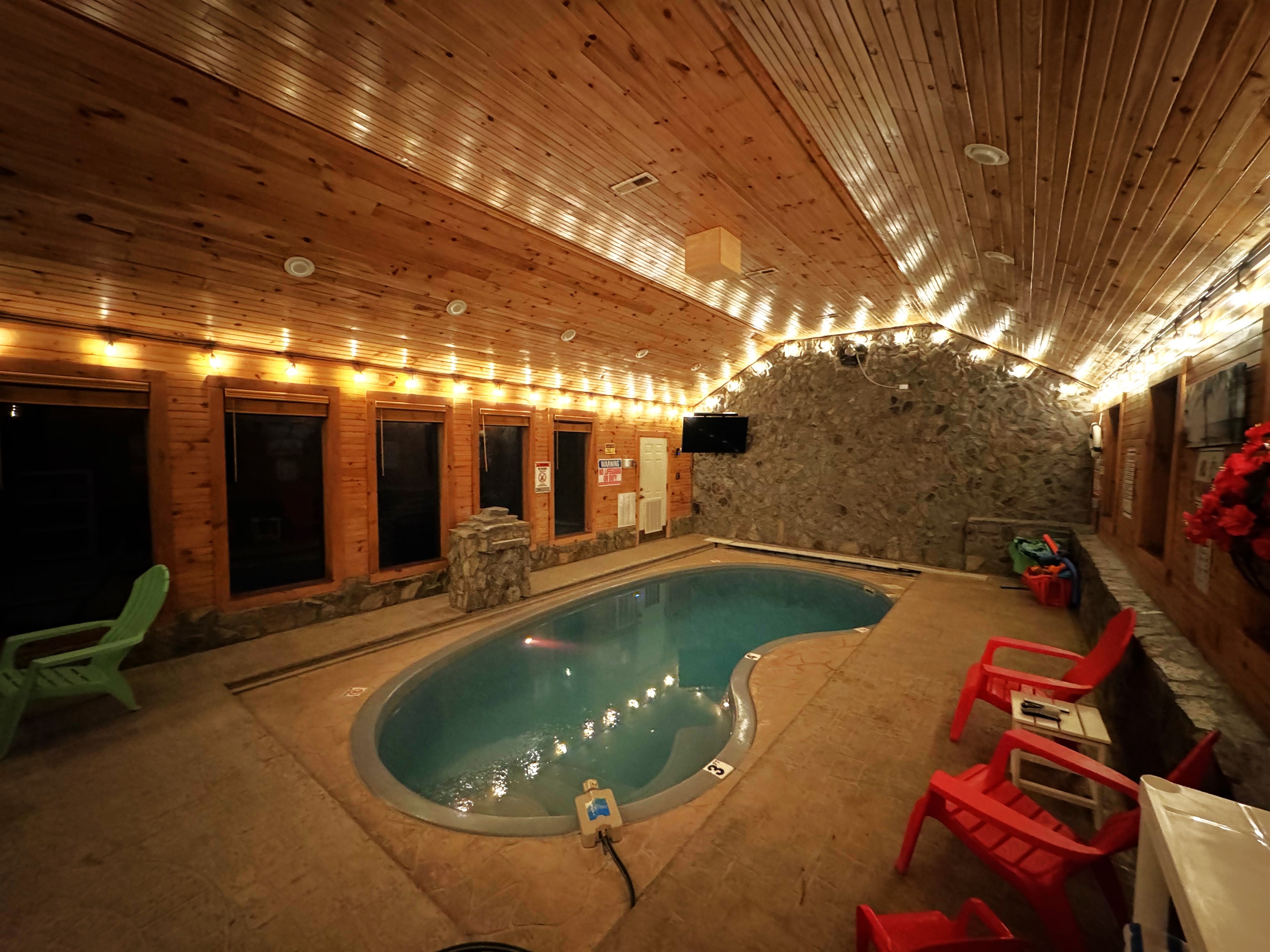 Nighttime view of pool with lighting