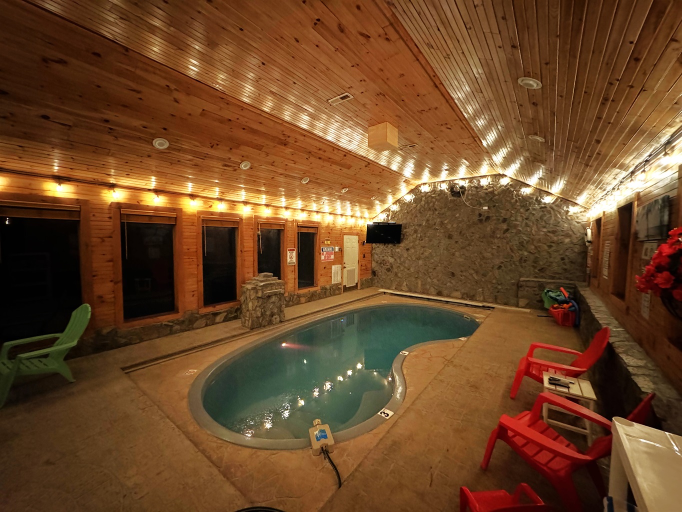 Nighttime view of pool with lighting
