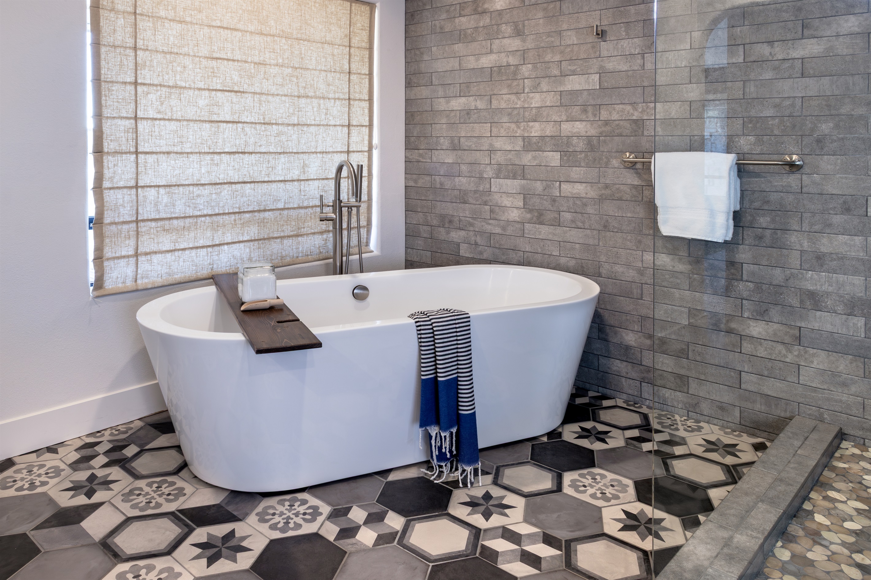 Sink in and let the day disappear. The freestanding soaking tub, natural light, and handcrafted tile floor create a bathing experience that rivals any luxury resort.