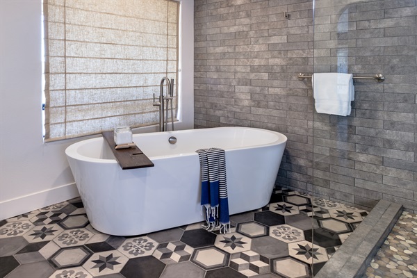 Sink in and let the day disappear. The freestanding soaking tub, natural light, and handcrafted tile floor create a bathing experience that rivals any luxury resort.