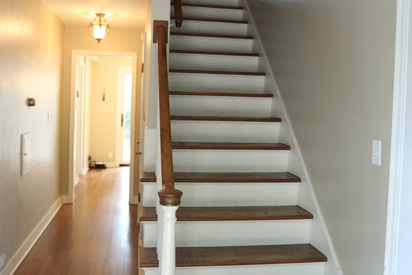 Foyer showing path to Living Room on the left, hallway to dinnette, stairs, and pathway to dining room to the right