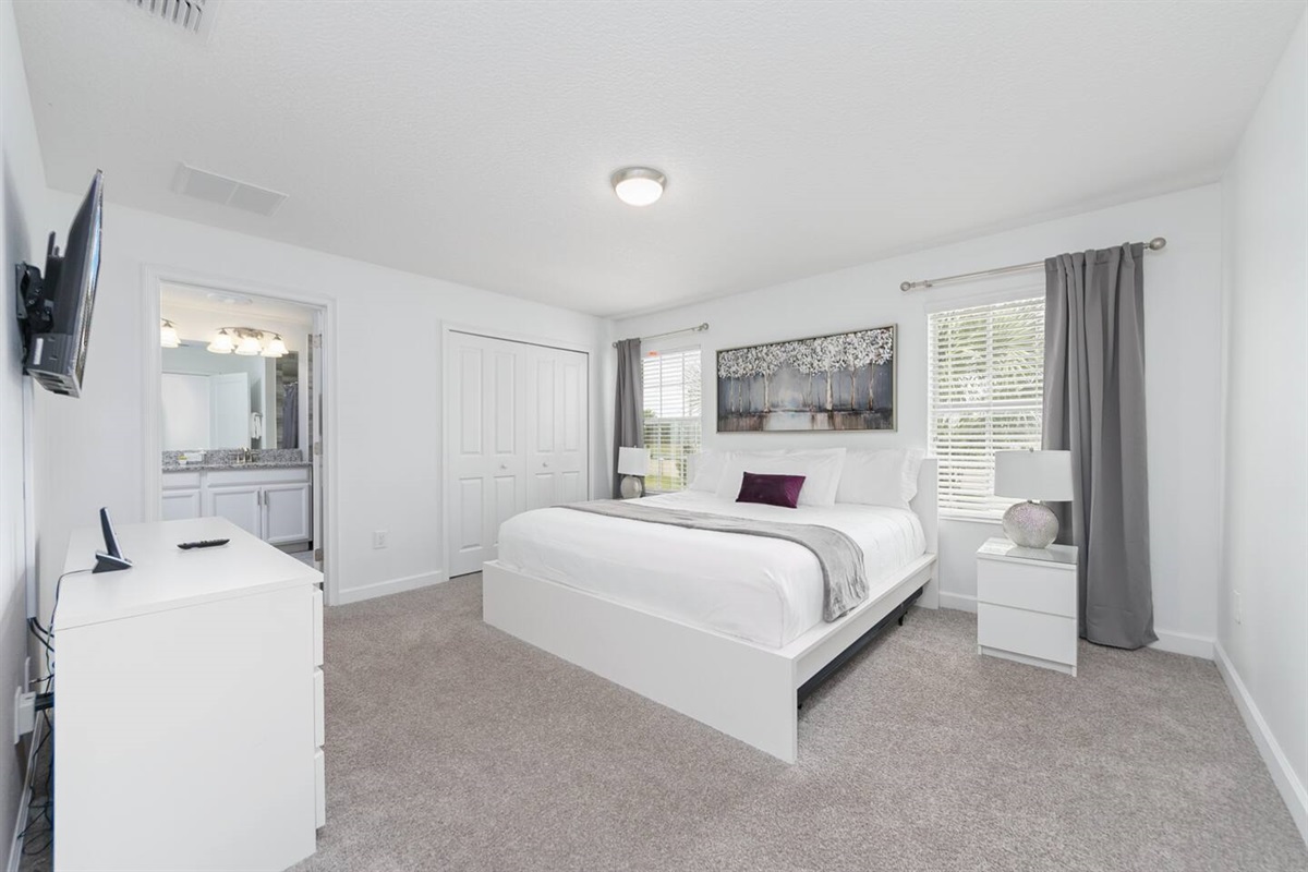 The master bedroom with a king bed, ensuite bathroom and TV, is upstairs