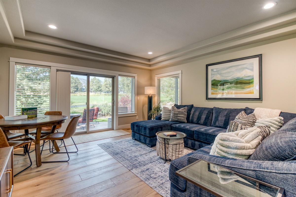 Downstairs living area with large screen streaming TV and poker table!  Beautiful windows & slider doors out to patio and golf course views.
