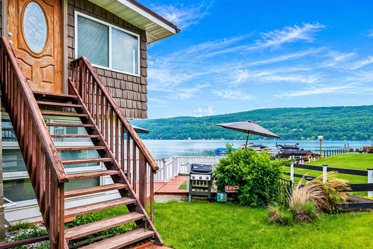 Lakeside retreat with stunning views, a cozy entry, and outdoor grill for relaxed dining.