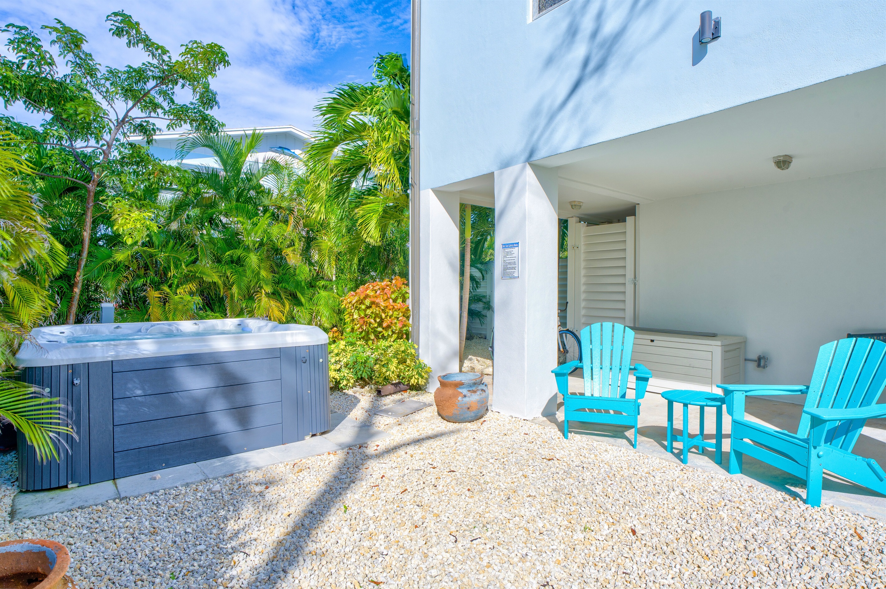 Tropical trees provide a secluded backyard area to relax.
