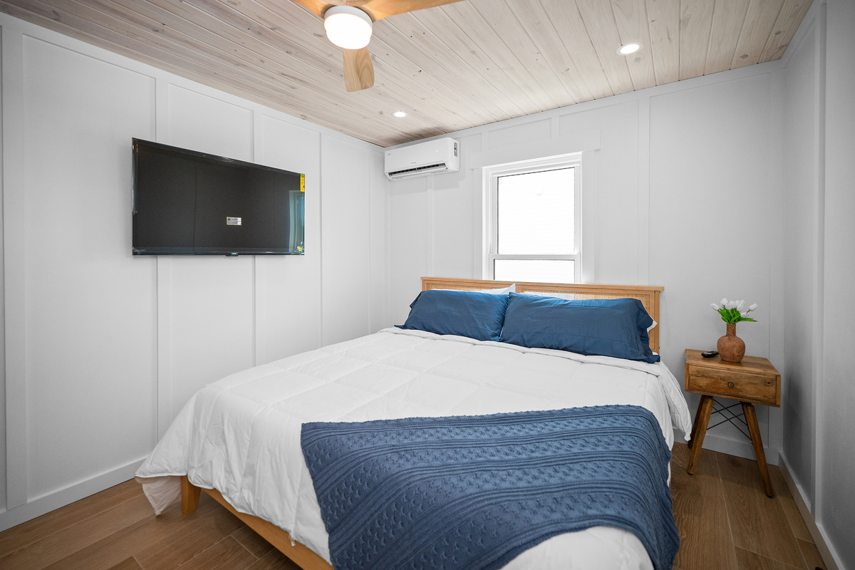 First-floor primary bedroom with a king bed, TV and private bathroom.