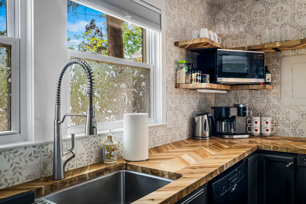 Large windows bring natural light into the kitchen throughout the day.