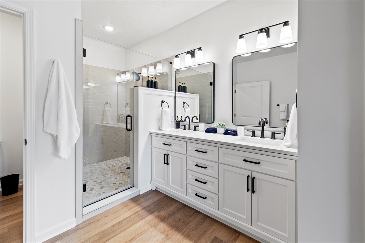 Luxurious master bathroom with oversized shower, private toilet room, roomy walk-in closet, and double sinks.