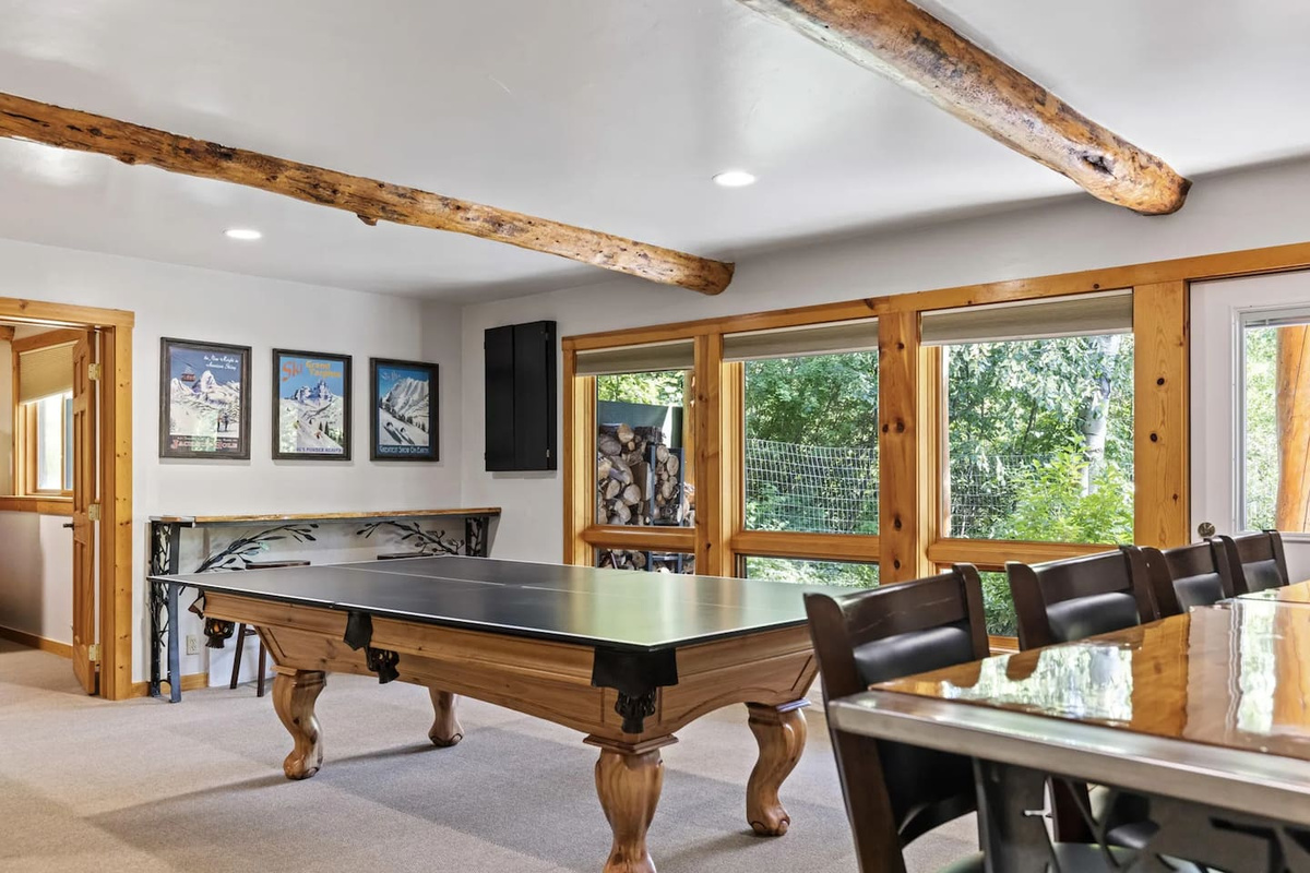Game Room with wood burning fireplace, ping pong, pool, darts, TV and access to patio.