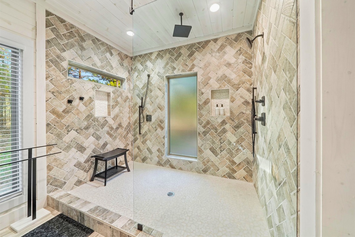 Modern bathroom with walk-in shower and patterned tile.