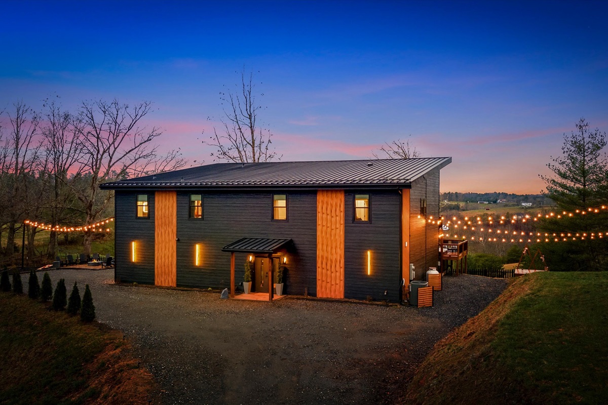 {Exterior Arrival}
Arrive to a private, elevated setting on 2 acres — modern architecture, warm lighting, and a sense of space, with plenty of parking, from the moment you pull in.