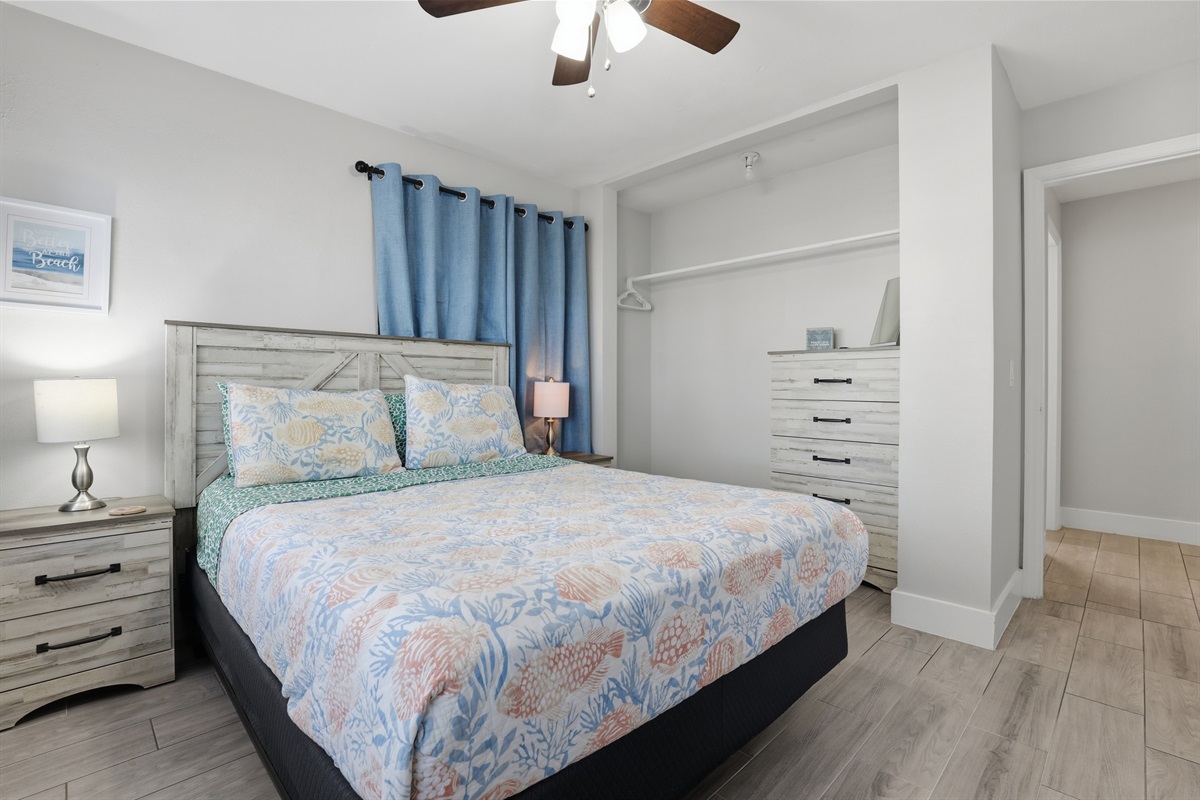 Guest bedroom one with queen bed, 2 nightstands, dresser and TV