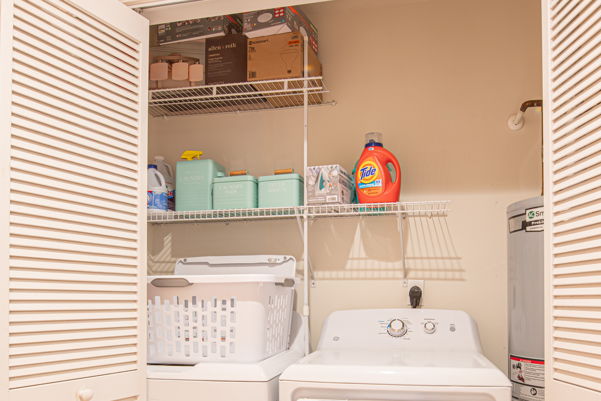 Laundry Closet with Washer, Dryer, and Storage Shelving