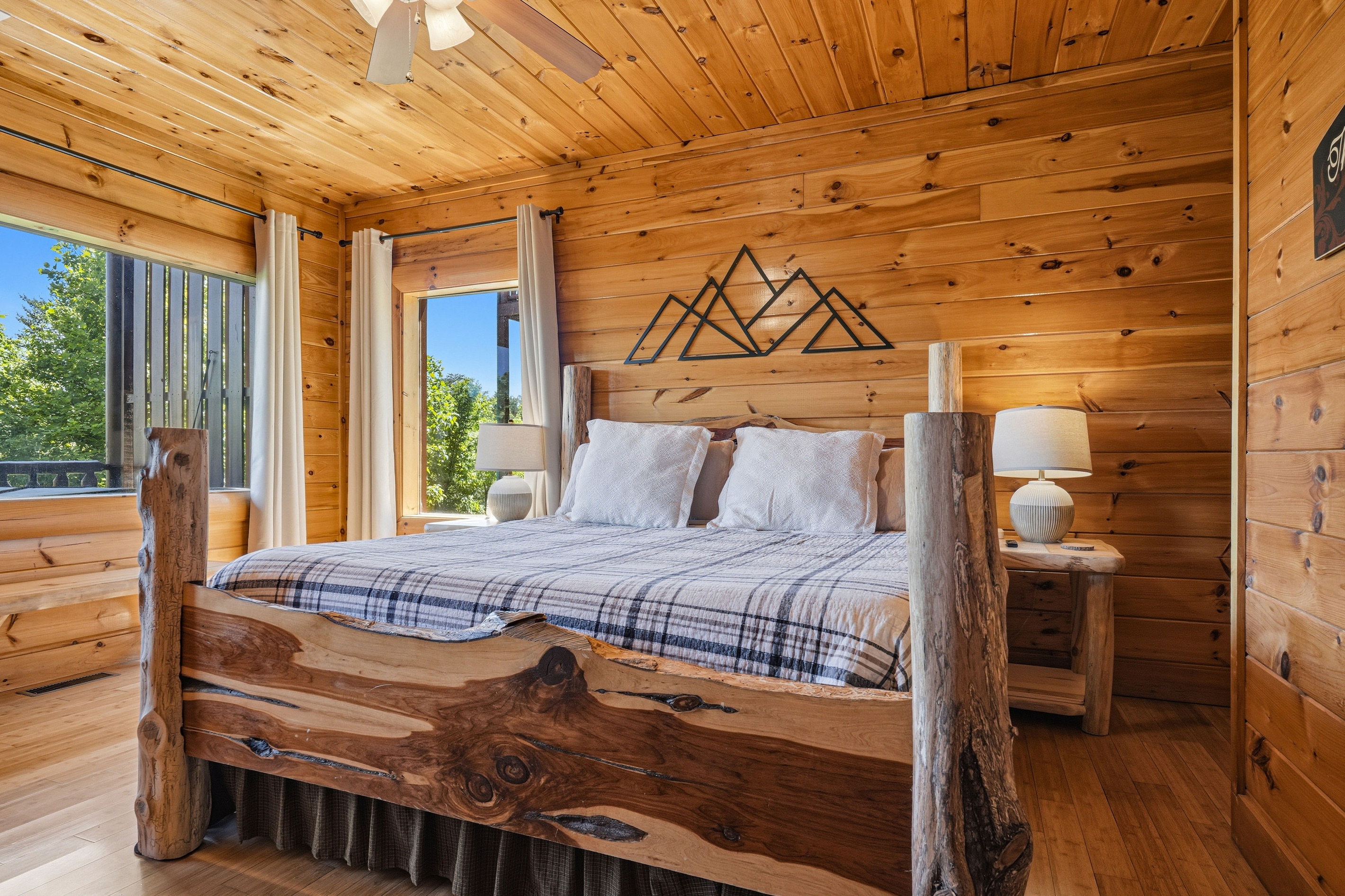Primary suite with rustic King log bed.