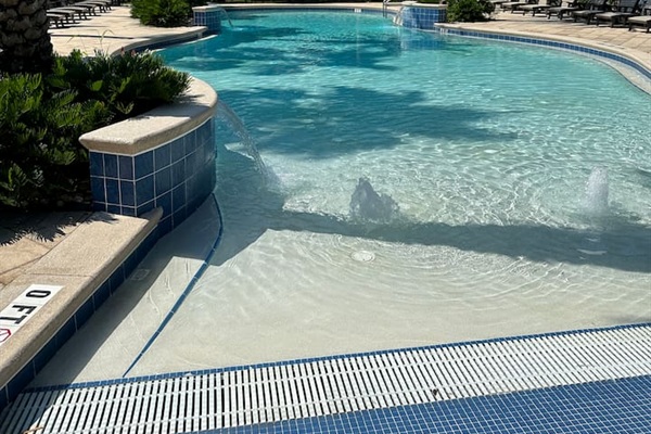 Resort-style pool just steps away through the stone path. Shared only with Creek Park at Magnolia homes, it features a zero-entry design perfect for kids and lounging under the palms. ☀️