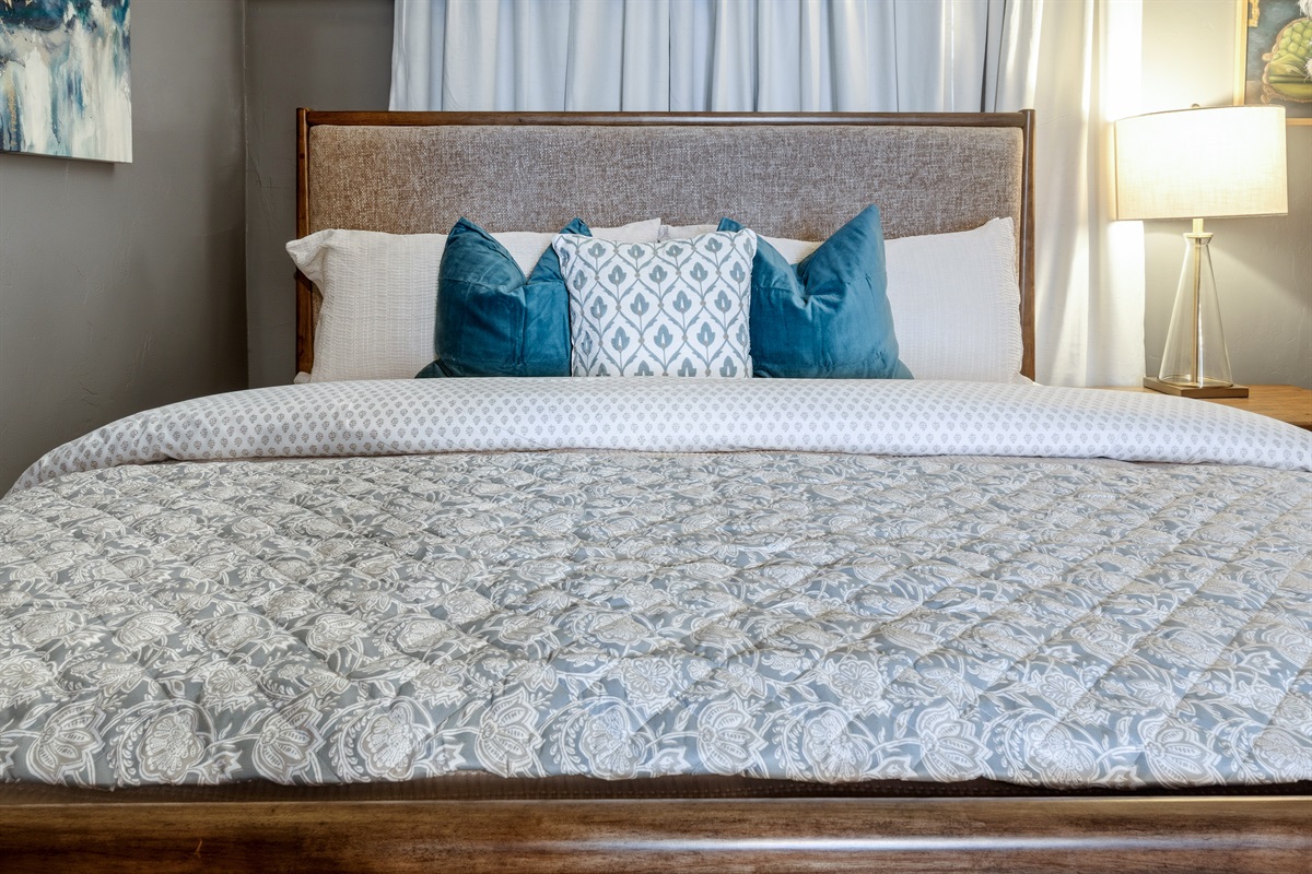 Quality linens and plush pillows on the king bed