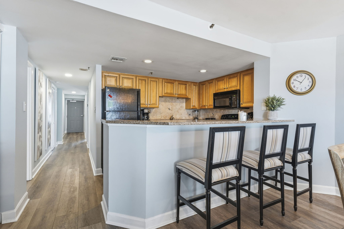 Breakfast bar with stools beside the kitchen