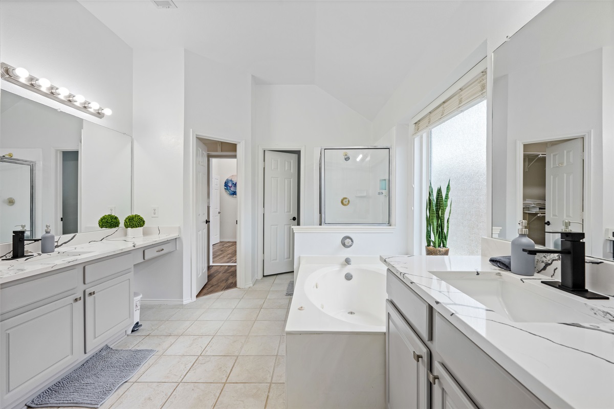 Ensuite primary bath with modern fixtures - comfort for your stay.