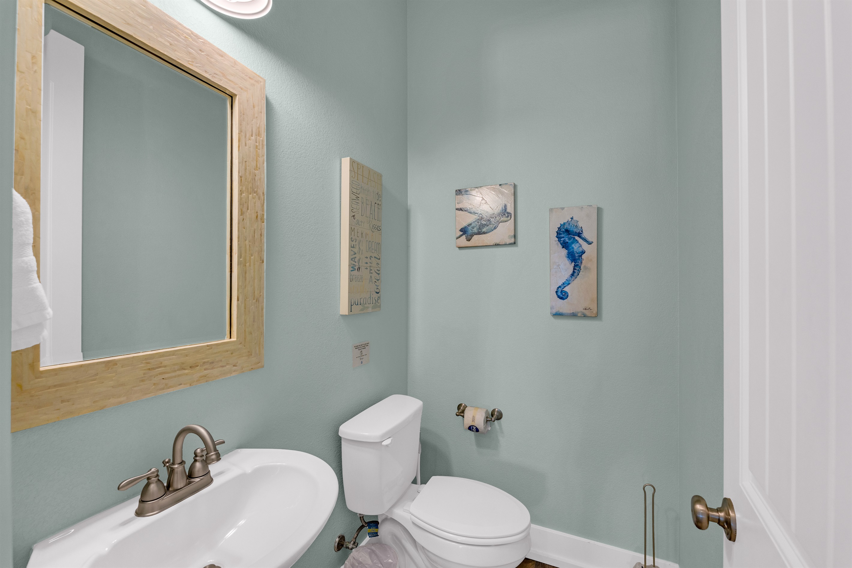 Sea It All: Half bathroom, single vanity, off the living room area on main floor.