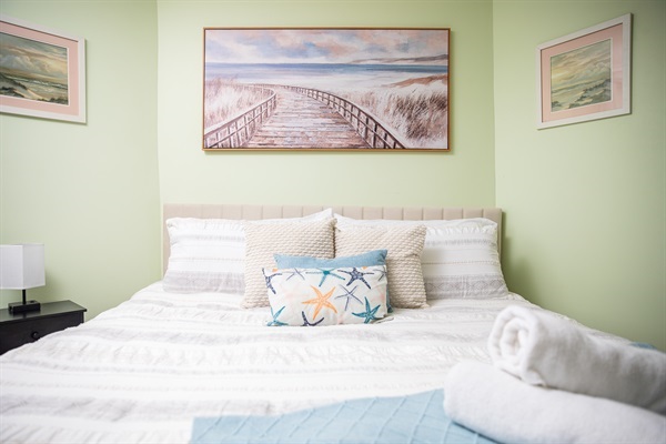 Spacious, cozy bedroom with a fireplace. Stretch out in the queen-sized bed while your little sleeps soundly in the crib.