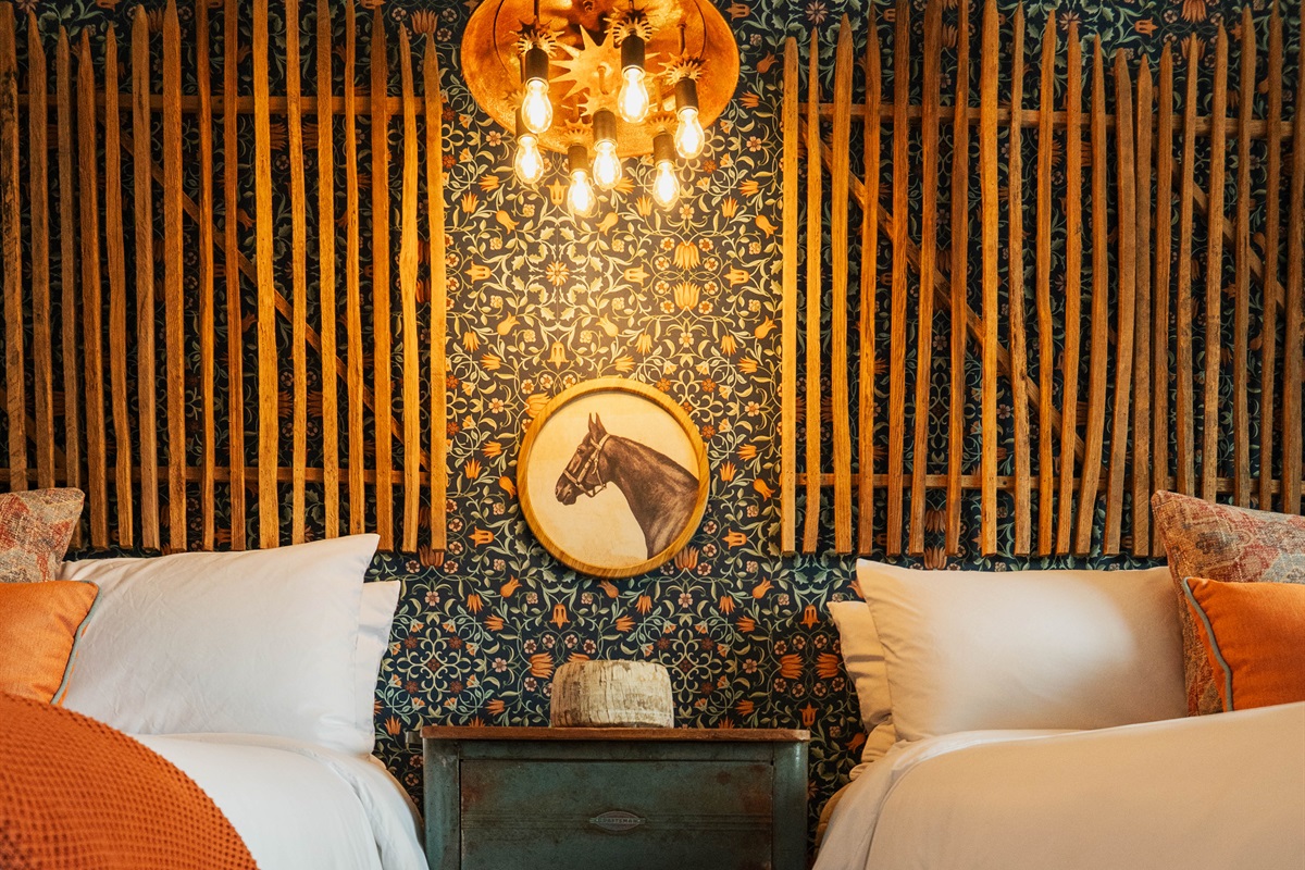 Premium Comphy linens at the Corral Suite — soft layered bedding and modern Western accents, Gaines Ranch on the Square.