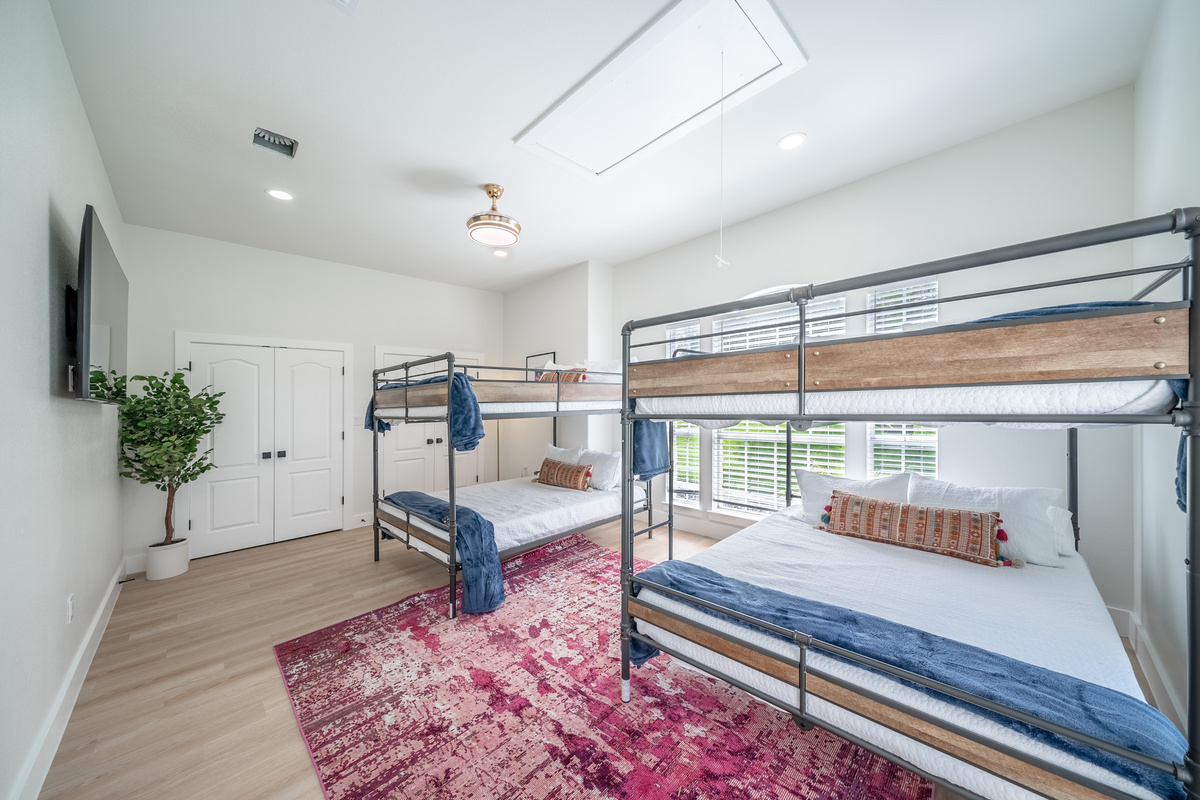 Natural light floods this spacious bunk room, ideal for larger families.