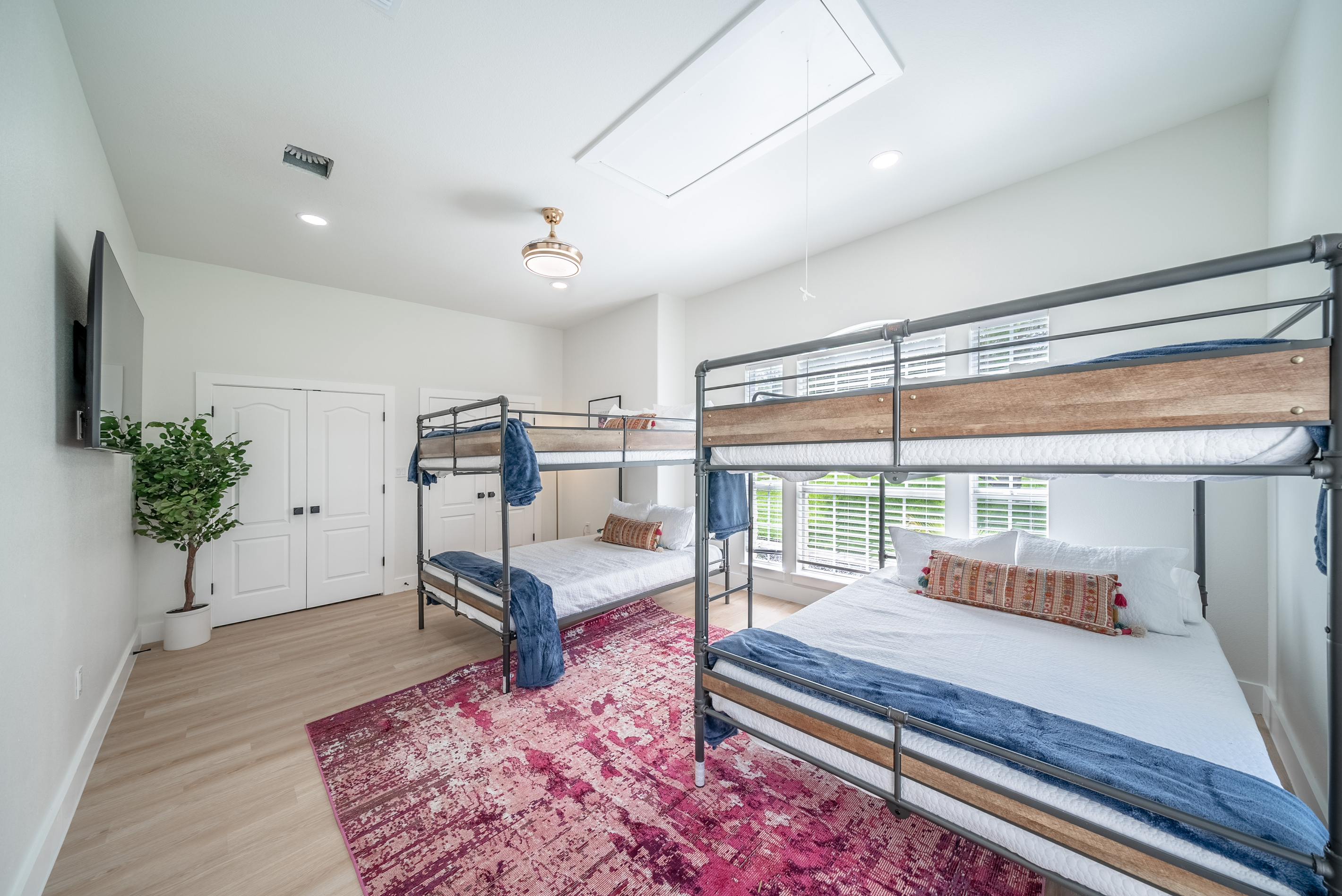 Natural light floods this spacious bunk room, ideal for larger families.