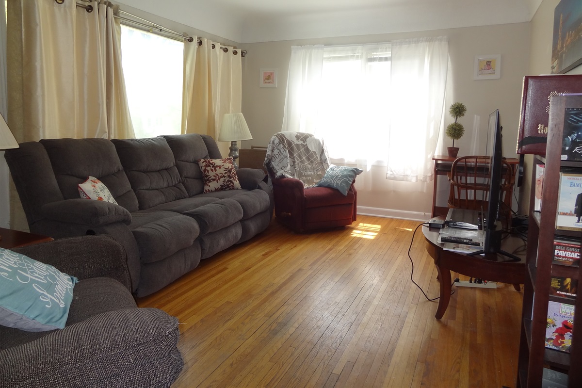 Living room with couch, recliners, and Roku smart TV